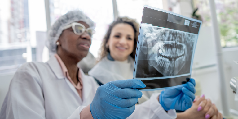 Patient discusses X-ray with dentist