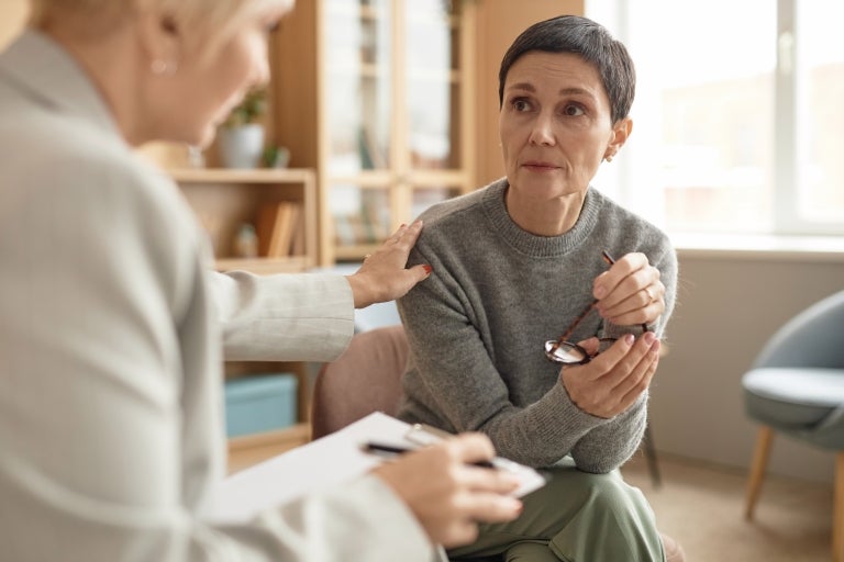 Woman being comforted by her therapist