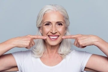 Oral Hygiene woman pointing at her teeth smiling