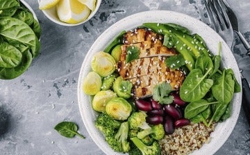 Healthy lunch with grilled chicken, quinoa, spinach, red beans, brussels sprouts, broccoli