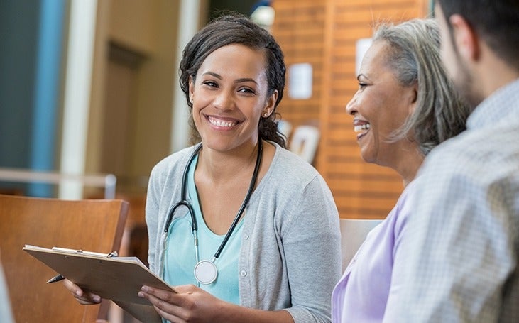 Female nurse practitioner consults with patients